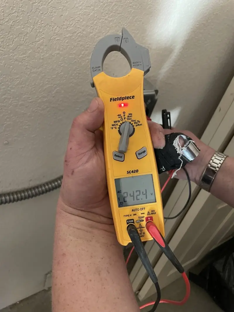 Voltage testing with clamp meter during Outlet Installation in Boardman